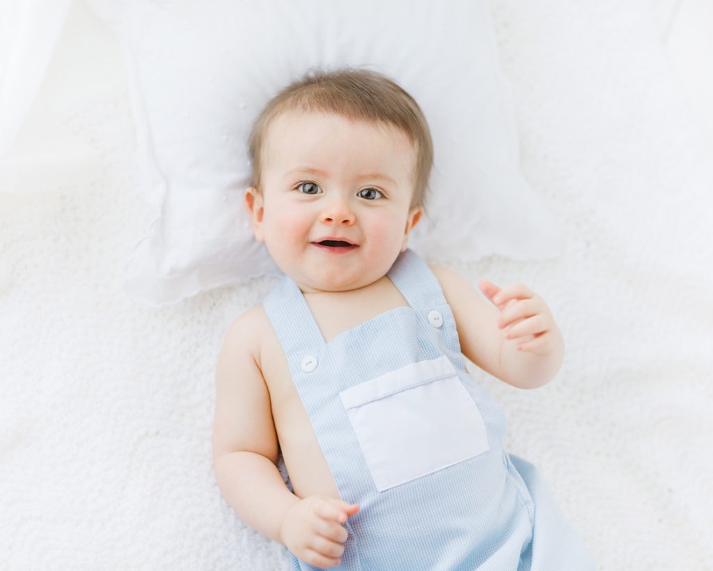 classic baby photography baby smiling on back by savannah photographer